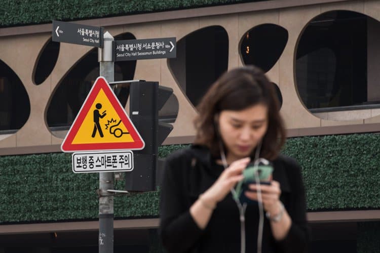 Traffic signs warning smartphone users to be careful Traffic signs warning smartphone users to be careful